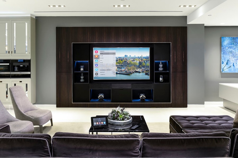 A media room featuring a Crestron interface on the coffee table.