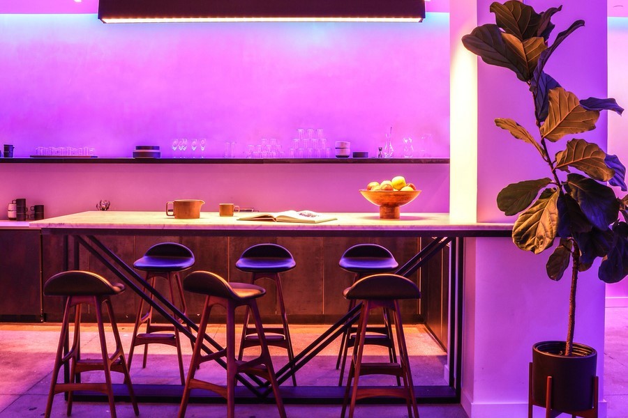 Ketra illuminates a kitchen bar area with purple and pink lighting