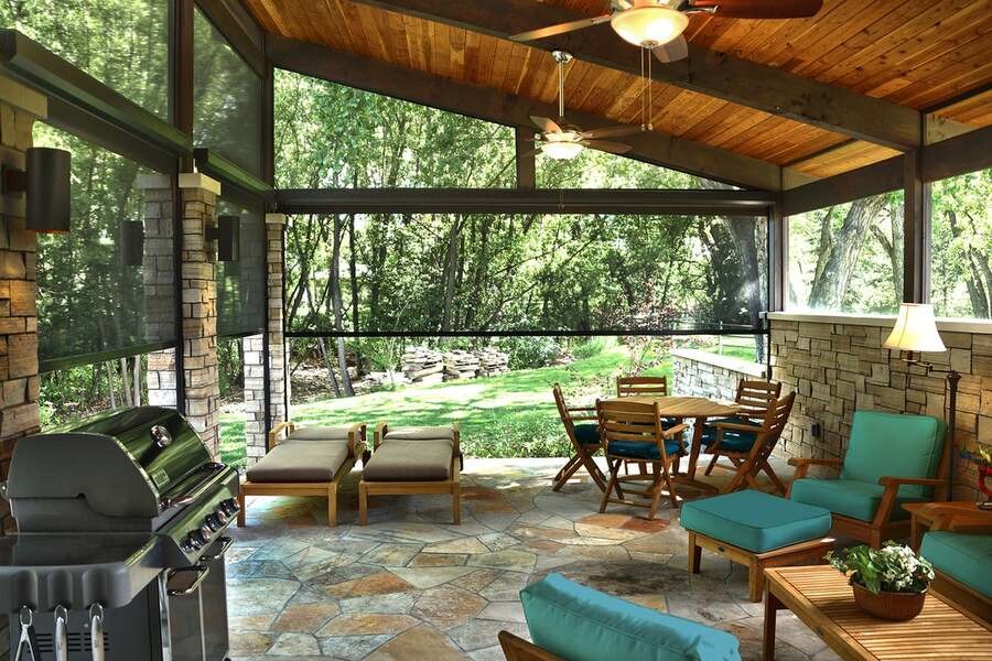 A luxury outdoor space with motorized patio shades.